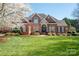 Charming two-story brick home with manicured lawn and mature landscaping, perfect for suburban living at 3071 Ancestry Cir, Matthews, NC 28104