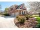 Angle view of a brick home with a two-car garage, mature landscaping, and curb appeal at 3071 Ancestry Cir, Matthews, NC 28104