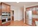 Spacious kitchen featuring hardwood floors, stainless steel fridge, and a built-in oven at 3071 Ancestry Cir, Matthews, NC 28104