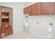 Bright laundry room featuring storage cabinets, a utility sink, and washer/dryer hookups at 3071 Ancestry Cir, Matthews, NC 28104