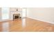 Bright living room featuring a fireplace, hardwood floors, and large windows at 3071 Ancestry Cir, Matthews, NC 28104