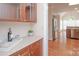 Pantry and hallway leading to open kitchen with stainless steel appliances at 3071 Ancestry Cir, Matthews, NC 28104