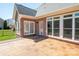Charming stone patio overlooking backyard with fenced yard and multiple windows to the home at 3071 Ancestry Cir, Matthews, NC 28104