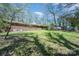 Large backyard shows the house with lots of green space at 340 Sardis N Rd, Charlotte, NC 28270