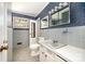 A bathroom offers tile details, a vanity and decorative wallpaper at 340 Sardis N Rd, Charlotte, NC 28270