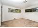 An empty bedroom features neutral carpet and two windows at 340 Sardis N Rd, Charlotte, NC 28270