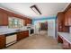 This kitchen features wooden cabinets, a window, and an opening with a lattice design at 340 Sardis N Rd, Charlotte, NC 28270