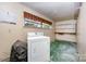 Functional laundry room features a washer, dryer, and shelving at 340 Sardis N Rd, Charlotte, NC 28270