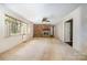 Spacious living room featuring a brick fireplace, large window, and neutral carpet, creating a comfortable and inviting space at 340 Sardis N Rd, Charlotte, NC 28270