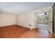 A large room with hardwood floors and an open doorway leading to another room, offering space and potential for customization at 340 Sardis N Rd, Charlotte, NC 28270
