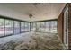 Enclosed sun room with brick accent wall and walls of windows at 340 Sardis N Rd, Charlotte, NC 28270