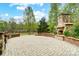 Backyard patio featuring stone fireplace, stone retaining walls, and paved flooring at 361 Nance Rd, Stanfield, NC 28163