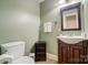 Cozy bathroom with neutral paint, wooden vanity and standard toilet and sink at 361 Nance Rd, Stanfield, NC 28163