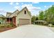 Exterior of home featuring a driveway, two-car garage, manicured lawn, and covered patio with fence at 361 Nance Rd, Stanfield, NC 28163