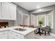 Bright kitchen with white cabinets, quartz countertops, stainless steel sink, and a cozy breakfast nook at 361 Nance Rd, Stanfield, NC 28163