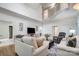 Open-concept living room with staircase, TV, and comfortable seating, showcasing a modern design at 361 Nance Rd, Stanfield, NC 28163