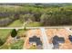 Aerial view of new construction showing home layout in a wooded neighborhood with landscaping at 3957 Miller Rd, Salisbury, NC 28147