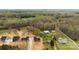 Lush aerial shot of new homes with outbuildings surrounded by a mix of pasture and wooded acreage at 3957 Miller Rd, Salisbury, NC 28147