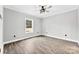 Comfortable bedroom featuring wood flooring, a window, and neutral paint scheme at 3957 Miller Rd, Salisbury, NC 28147
