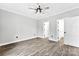 Neutral bedroom with wood flooring, ceiling fan, and two doorways at 3957 Miller Rd, Salisbury, NC 28147