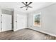 Bedroom features wood floor, a ceiling fan, closet, and natural light from the window at 3957 Miller Rd, Salisbury, NC 28147