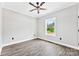 Bedroom boasts a ceiling fan, wood flooring, and a window providing ample light at 3957 Miller Rd, Salisbury, NC 28147