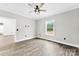 This bedroom features neutral walls, wood floors, and a window overlooking the yard at 3957 Miller Rd, Salisbury, NC 28147