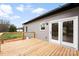New wooden deck with double doors offers a relaxing outdoor space and complements the home's exterior at 3957 Miller Rd, Salisbury, NC 28147