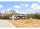 Charming single-story home features gray siding, stone accents, and an attached two-car garage at 3957 Miller Rd, Salisbury, NC 28147