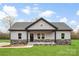Inviting single-story home with gray siding, stone accents, and a covered front porch at 3957 Miller Rd, Salisbury, NC 28147