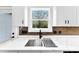 Modern kitchen boasts a stainless steel sink, elegant countertops, and a window with a view at 3957 Miller Rd, Salisbury, NC 28147