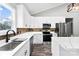 Modern kitchen with a stylish faucet and sink, stainless steel appliances, and white countertops at 3957 Miller Rd, Salisbury, NC 28147