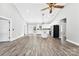Bright, airy living room featuring wood floors, vaulted ceilings, and an open kitchen layout at 3957 Miller Rd, Salisbury, NC 28147