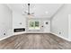 Inviting living room with a fireplace accent wall, adjacent window, and hardwood floors at 3957 Miller Rd, Salisbury, NC 28147