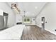 Bright living room with vaulted ceiling, fireplace, wood floors, and a view from the door at 3957 Miller Rd, Salisbury, NC 28147