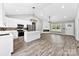 Bright open living room flows into a modern kitchen with stainless appliances, and a cozy fireplace at 3957 Miller Rd, Salisbury, NC 28147