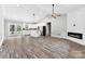Open-concept living area with wood flooring, white walls, and modern fireplace at 3957 Miller Rd, Salisbury, NC 28147