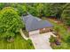 Overhead view showcasing the home's well-manicured lawn and attached garage, enveloped by mature trees at 4159 Isle Of Pines Dr, Denver, NC 28037