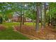 Expansive backyard with mature trees and a wrought iron fence at 4159 Isle Of Pines Dr, Denver, NC 28037