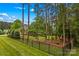 An expansive green lawn with mature trees creating a serene, private oasis at 4159 Isle Of Pines Dr, Denver, NC 28037