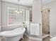 This bathroom offers a soaking tub under a glass block window and tiled shower at 4159 Isle Of Pines Dr, Denver, NC 28037