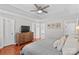 This bedroom is spacious with wood floors and a view into the bathroom at 4159 Isle Of Pines Dr, Denver, NC 28037