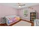 bedroom with pink walls, hardwood floors and a bookshelf at 4159 Isle Of Pines Dr, Denver, NC 28037