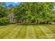 Beautiful brick home boasting a meticulously maintained lawn and mature trees at 4159 Isle Of Pines Dr, Denver, NC 28037