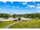 Picturesque lakeside view with lush green lawns and inviting sitting areas under a blue sky at 4159 Isle Of Pines Dr, Denver, NC 28037