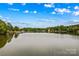 Calm lake view reflecting the sky and surrounding trees, offering a peaceful waterfront setting at 4159 Isle Of Pines Dr, Denver, NC 28037
