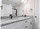 Bathroom featuring double sinks, granite countertops, and modern black fixtures at 4219 Brownwood Nw Ln, Concord, NC 28027