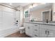 Bathroom with a tub-shower combo, dual-sink vanity, and granite counters at 4219 Brownwood Nw Ln, Concord, NC 28027
