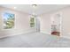 Bright bedroom with plush gray carpeting, neutral paint, and ensuite bathroom access at 4219 Brownwood Nw Ln, Concord, NC 28027