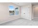 Bedroom with plush gray carpeting, closet, and a view of the neighborhood at 4219 Brownwood Nw Ln, Concord, NC 28027